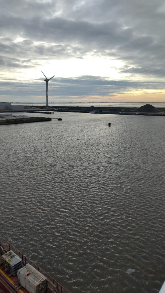Windrad im Meer bei Sonnenuntergang am Hafen – transporttechniker.de